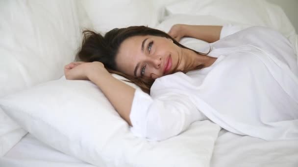 Woman wakes up raise stretches hands in bed feels healthy - Video, Çekim