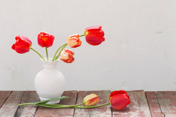 tulips in vase on white old background  - Photo, Image