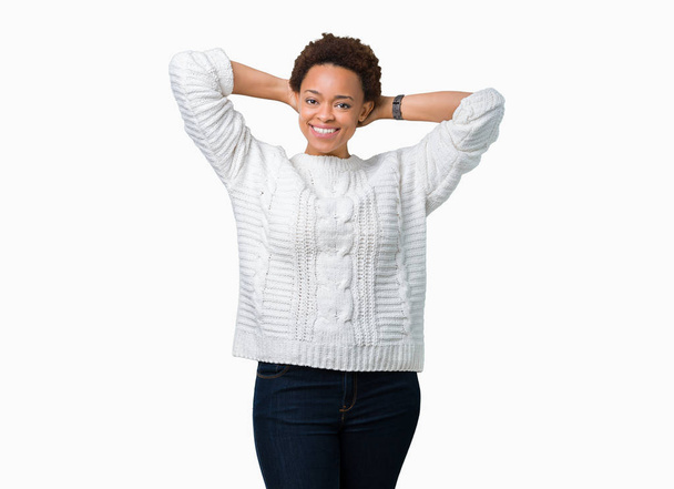 Beautiful young african american woman wearing sweater over isolated background Relaxing and stretching with arms and hands behind head and neck, smiling happy - Fotó, kép