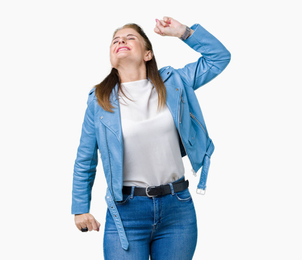 Beautiful middle age mature woman wearing fashion leather jacket over isolated background stretching back, tired and relaxed, sleepy and yawning for early morning - Fotoğraf, Görsel