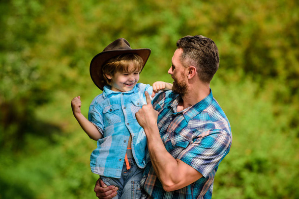 Spirit of adventures. Strong like father. Power being father. Child having fun cowboy dad. Rustic family. Growing cute cowboy. Small helper in garden. Little boy and father in nature background - Фото, зображення