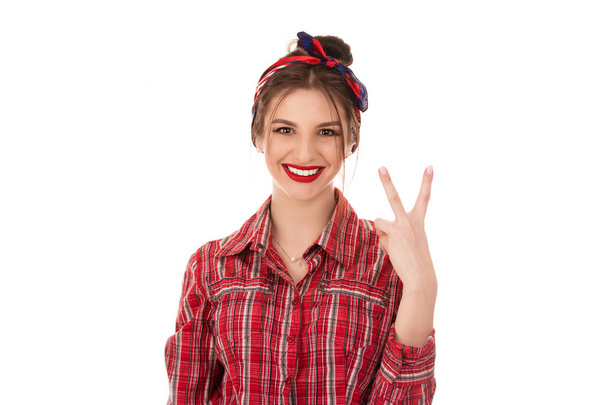 Woman is showing peace, victory sign and smiling - Фото, изображение