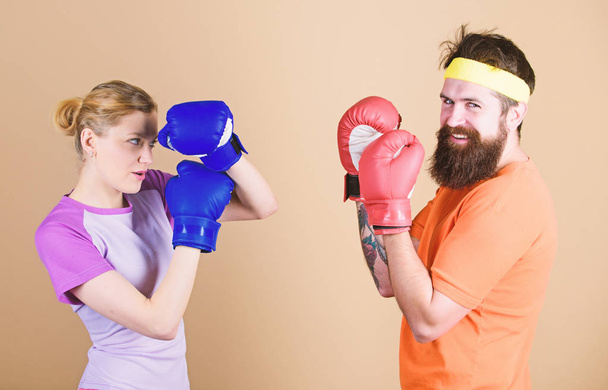 Man and woman in boxing gloves. Boxing sport concept. Couple girl and hipster practicing boxing. Sport for everyone. Amateur boxing club. Equal possibilities. Strength and power. Ready to fight - Foto, immagini
