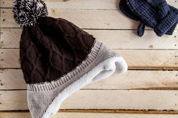 warm baby hat on wooden background - Fotó, kép