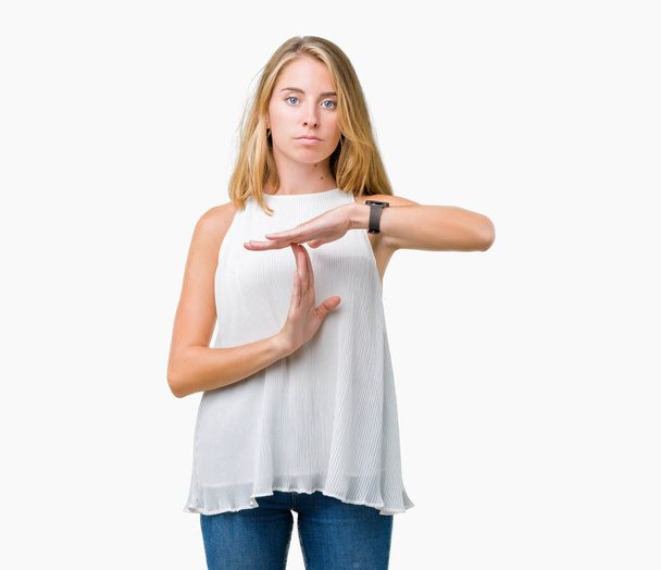 Beautiful young elegant woman over isolated background Doing time out gesture with hands, frustrated and serious face - Фото, изображение