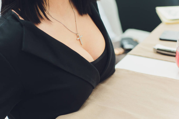 Decollete, female breast. Neckline black dress and fur collar. - Fotó, kép