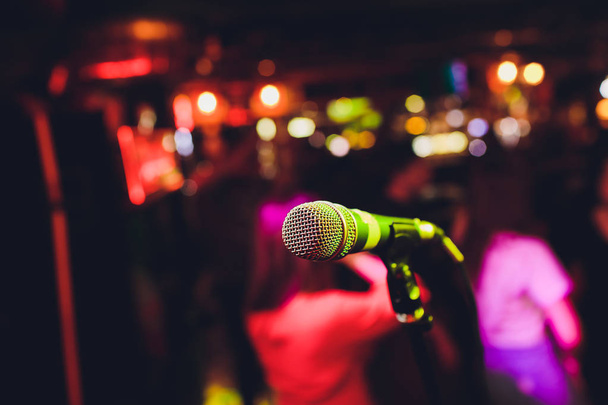Microphone on stage against a background of auditorium. - Φωτογραφία, εικόνα