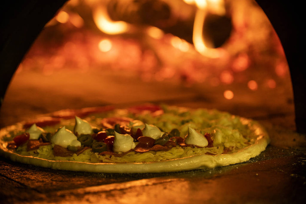 Italian pizza inside a wood oven  - Foto, immagini