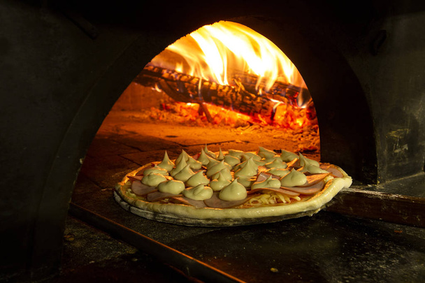 Italian pizza inside a wood oven  - Фото, зображення
