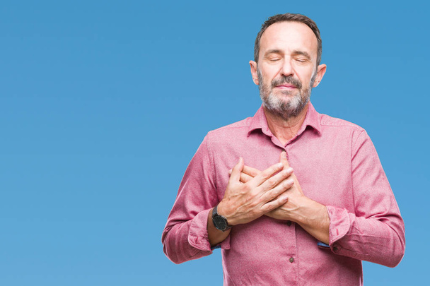 Middle age hoary senior man over isolated background smiling with hands on chest with closed eyes and grateful gesture on face. Health concept. - Foto, immagini