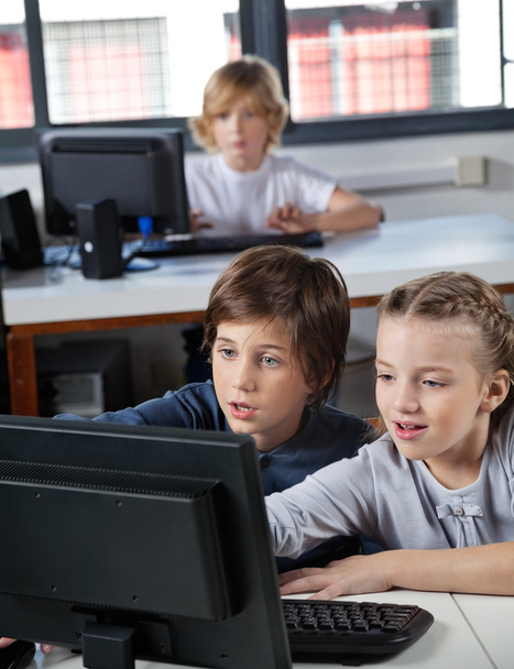 Little Schoolchildren Looking At Computer Monitor - Foto, Imagen