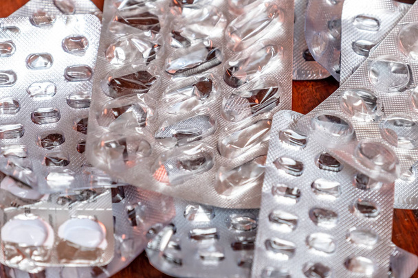 Empty blister packaging of medicine pills on wooden table - Foto, Imagem
