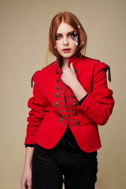 Young woman with stylish make-up wearing red jacket                  - Foto, afbeelding