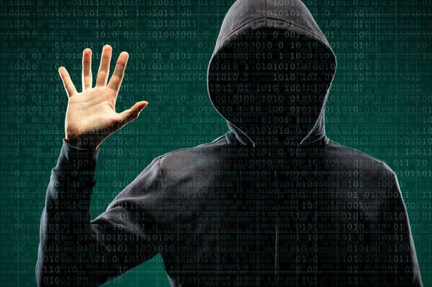 Dangerous hacker over abstract digital background with binary code. Obscured dark face in mask and hood. Data thief, internet attack, darknet fraud, virtual reality and cyber security concept. - Fotografie, Obrázek