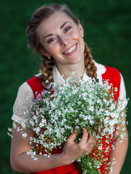 Girl student in park with flowers - Fotó, kép