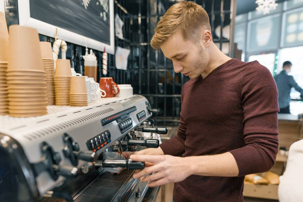 Portrait of young male barista making drinks. Coffee shop business concept - Foto, afbeelding