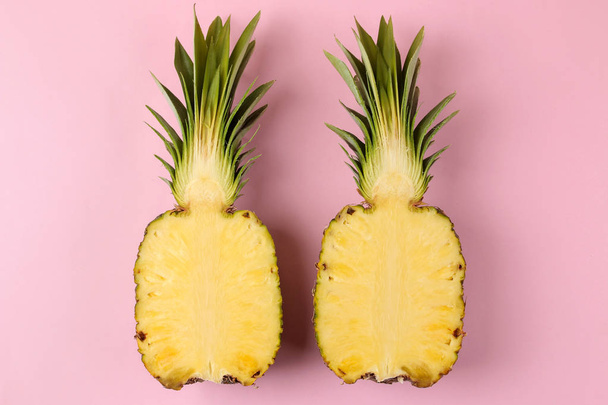Large ripe fruit pineapple on a bright pink background. summer. top view. - Foto, imagen