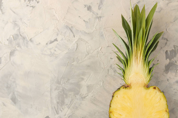 Grande frutta matura ananas. Mezzo ananas su uno sfondo di cemento chiaro. estate. vista dall'alto. spazio per il testo
 - Foto, immagini