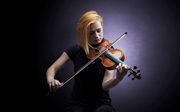 Violinst playing on instrument with empathy - Фото, зображення