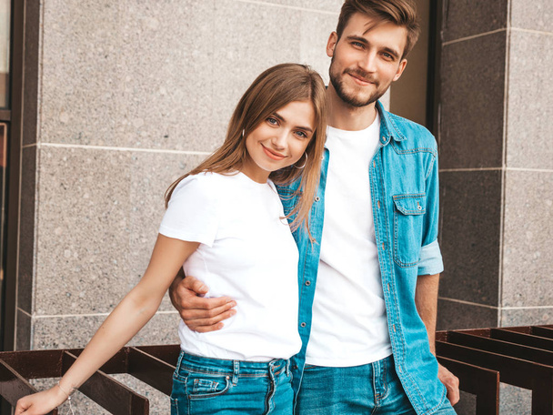 Portrait of smiling beautiful girl and her handsome boyfriend in casual summer clothes. Happy cheerful family having fun on the street background  - Foto, Imagem