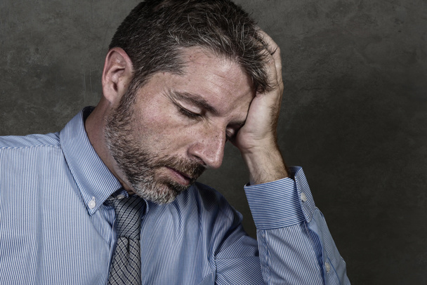 businessman in shirt and necktie suffering depression problem feeling tired and overwhelmed isolated on grunge background in company business stress and overwork - Photo, Image