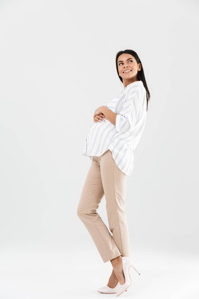 Full length photo of european pregnant businesswoman 30s smiling - Fotoğraf, Görsel