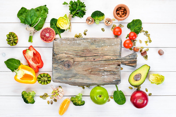 Voedingsmiddelen die natuurlijke vezels bevatten: avocado's, kiwi, appel, tomaten, spinazie, paprika, sinaasappel, citroen. Bovenaanzicht. Vrije ruimte voor uw tekst. Op een witte achtergrond. - Foto, afbeelding