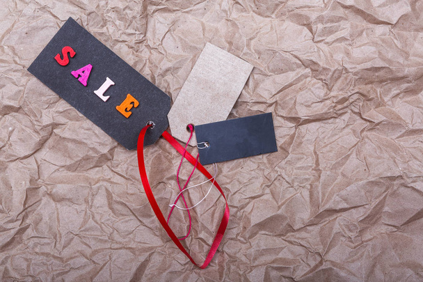tag with the inscription sale on the background of old crumpled paper - 写真・画像