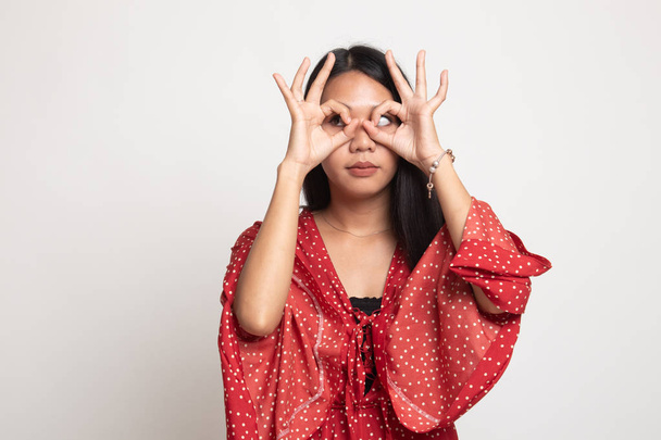 Asian woman do funny  double OK sign as glasses. - Foto, Bild