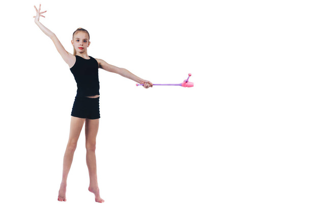 Teenager girl gymnast holds in hands clubs for rhythmic gymnastics - Фото, изображение