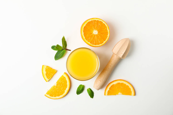 Flat lay composition with orange juice, orange pieces, mint and  - Фото, изображение