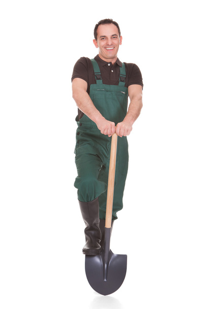 Portrait Of A Male Worker Holding A Shovel - Foto, immagini