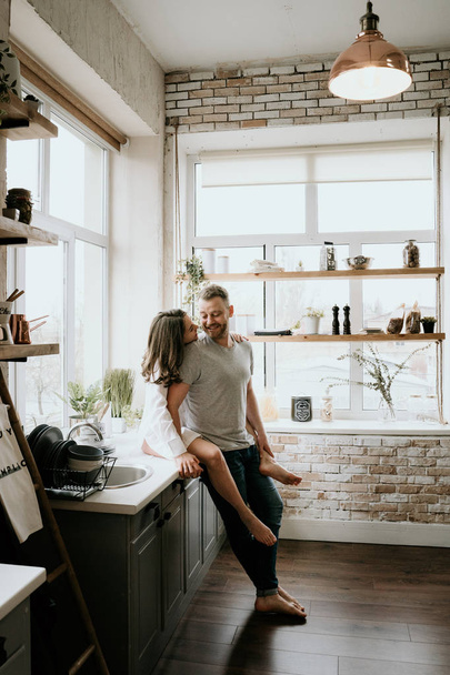 Romantic young couple cooking together in the kitchen,having a great time together. - Photo, image
