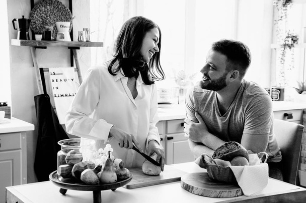 Romantic young couple cooking together in the kitchen,having a great time together. - 写真・画像