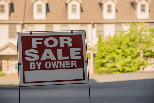 For sale by owner sign in front of a row of townhouses - Photo, Image
