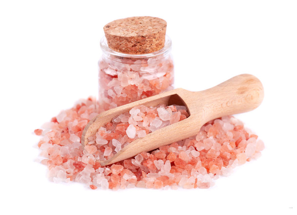Himalayan pink salt in glass jar, with wooden spoon, isolated on white background. Himalayan pink salt in crystals. - Photo, Image