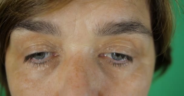 4K - Woman looks up and looks in camera in surprise, her eyes close up - Footage, Video