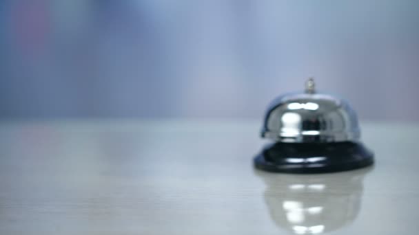 Female hand putting Hotel room keys near bell on reception, hospitality services - Video, Çekim
