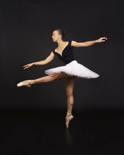 Gorgeous ballerina in a white tutu dancing ballet. - Fotoğraf, Görsel