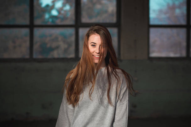 Portrait of cute, redhead teenage girl in gray sweater. - Foto, imagen
