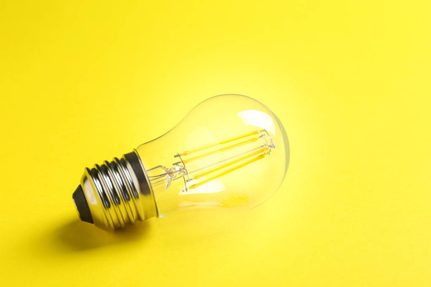 New modern lamp bulb on color background - Foto, Imagem