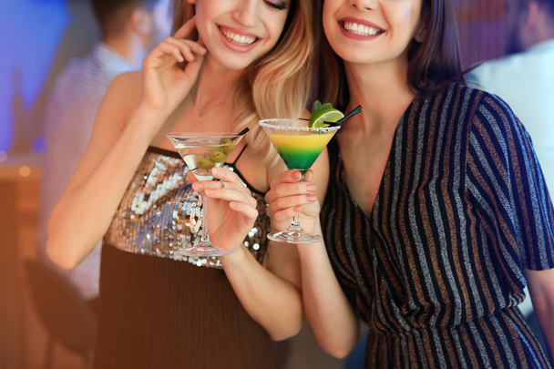 Young women with martini cocktails in bar, closeup - Zdjęcie, obraz
