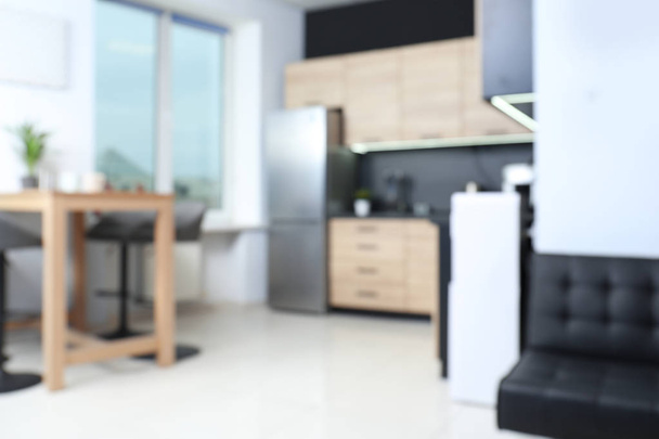 Blurred view of cozy modern kitchen interior with new furniture and appliances - Φωτογραφία, εικόνα