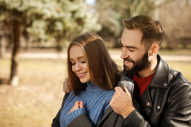 Portrait of cute young couple in park on sunny day - Photo, image
