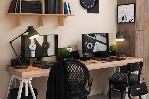 Stylish workplace interior with computers on table - Zdjęcie, obraz