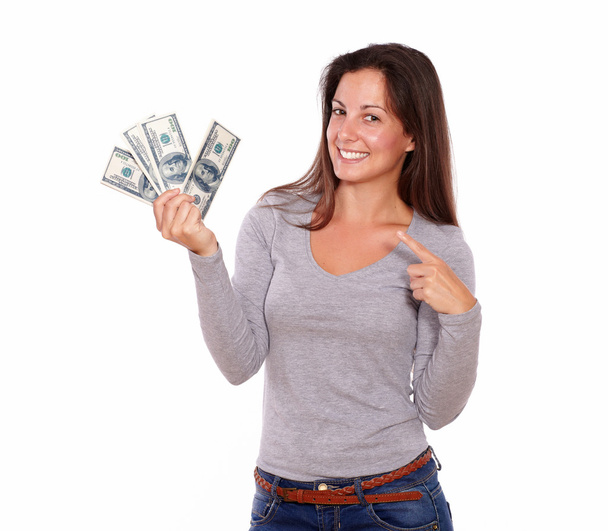 Lovely lady holding dollars while standing - Valokuva, kuva