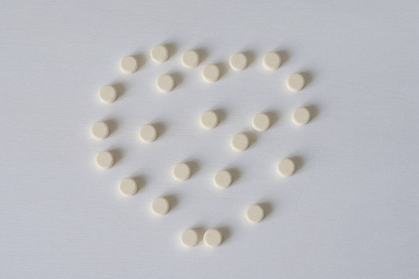 Pills on a white background. The concept of medicine, pharmacy and health care - Фото, зображення