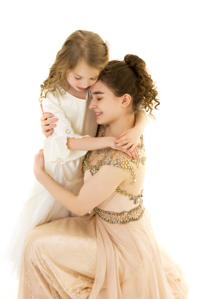 A young girl hugs her little sister. - Valokuva, kuva