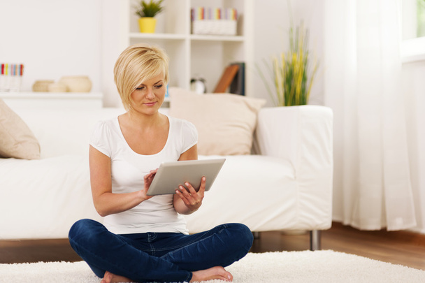 Young woman using digital tablet at home - Photo, Image