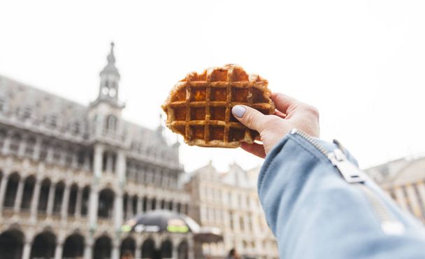 Traditional Belgian waffle on the background of the Grand-Place, Belgium - Photo, Image
